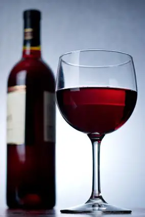 Vaso y botella de vino tinto
